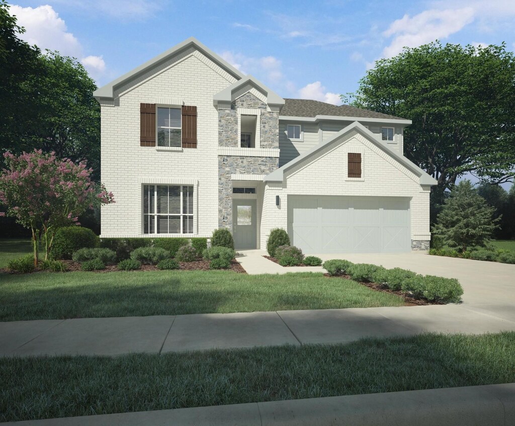 view of front of home featuring a front yard and a garage