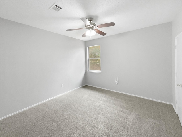 spare room featuring carpet floors and ceiling fan