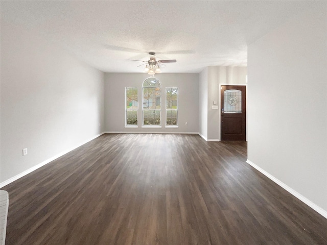 unfurnished living room with ceiling fan, dark hardwood / wood-style flooring, and a textured ceiling