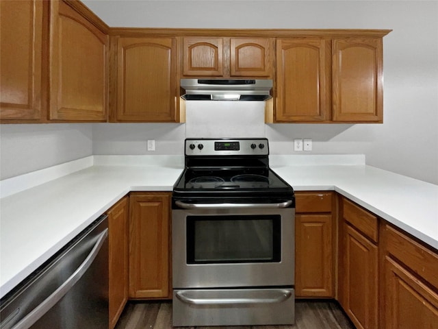 kitchen featuring stainless steel appliances and dark wood-type flooring