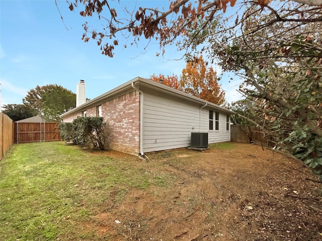 view of home's exterior featuring a yard and central air condition unit