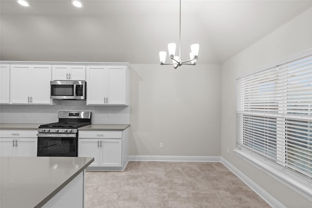 kitchen with backsplash, an inviting chandelier, appliances with stainless steel finishes, decorative light fixtures, and white cabinetry