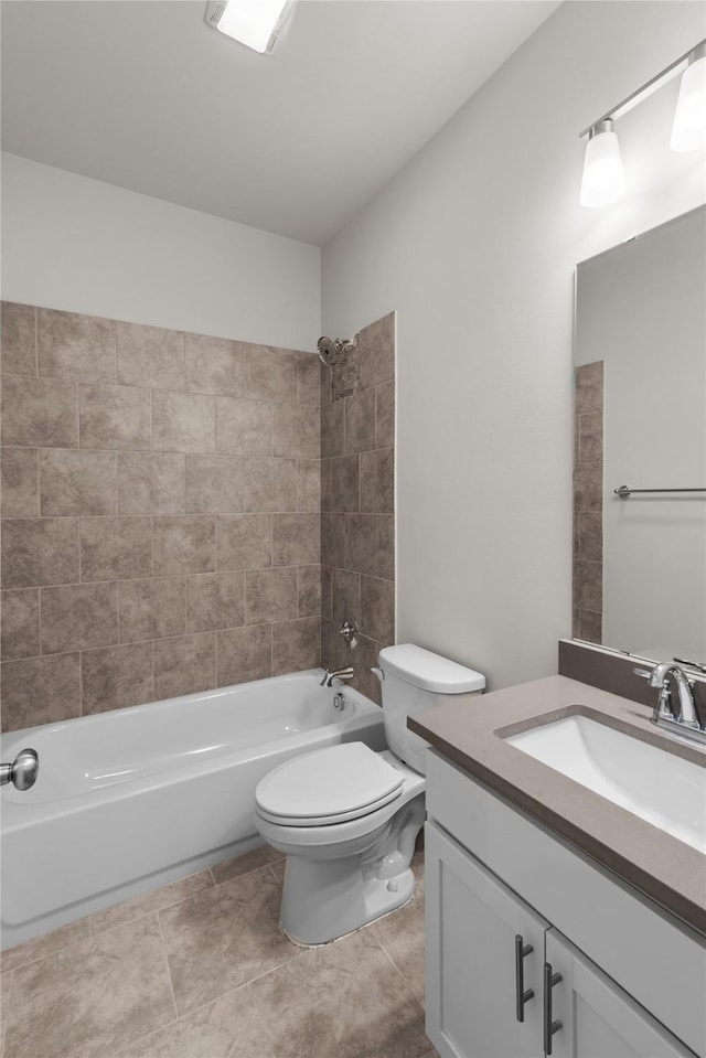 full bathroom featuring tile patterned floors, tiled shower / bath combo, toilet, and vanity