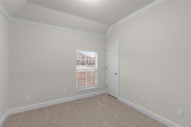 spare room with lofted ceiling, light carpet, and ornamental molding