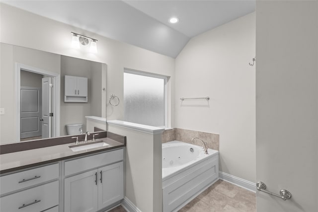 bathroom featuring a washtub, tile patterned flooring, vaulted ceiling, toilet, and vanity