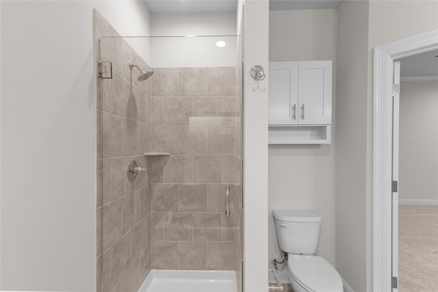 bathroom featuring toilet and a shower with shower door