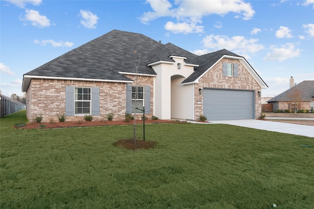 view of front of house with a garage and a front yard