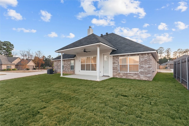 rear view of house featuring ceiling fan, a patio area, a yard, and central air condition unit