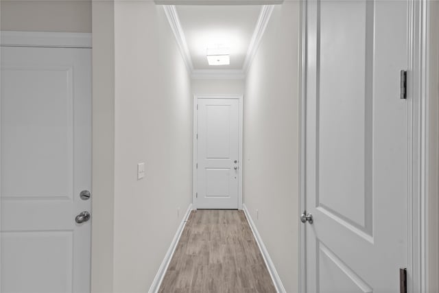 hall with crown molding and light hardwood / wood-style flooring