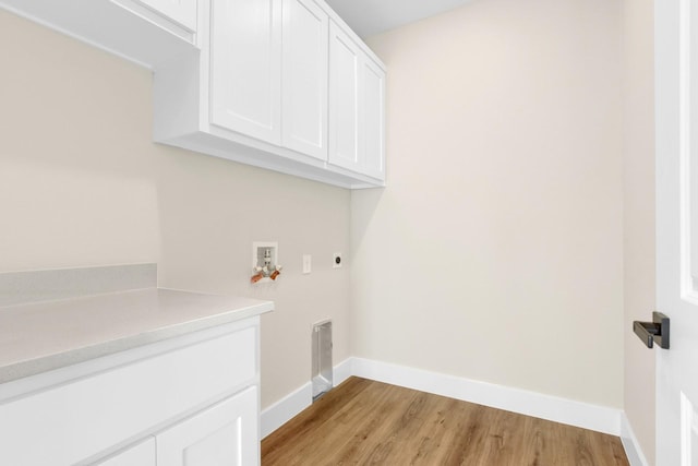 laundry area featuring cabinets, hookup for an electric dryer, hookup for a washing machine, and light wood-type flooring