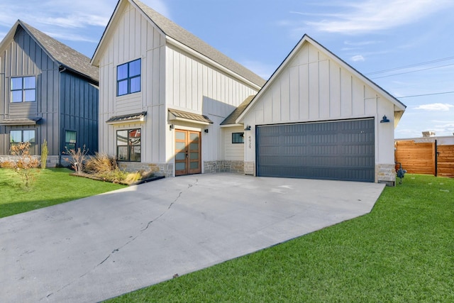 modern farmhouse style home with a garage and a front lawn