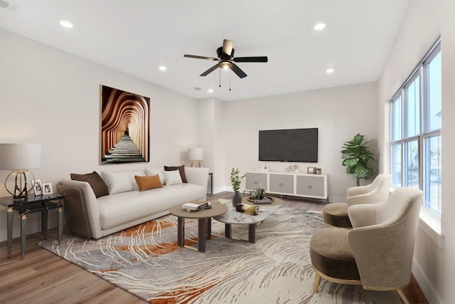 living room featuring hardwood / wood-style flooring and ceiling fan