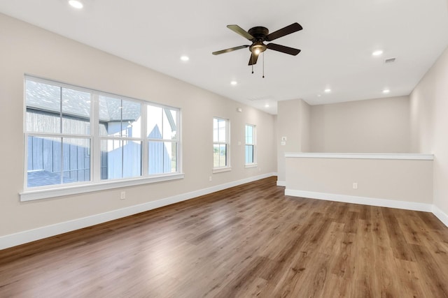 unfurnished living room with wood-type flooring and ceiling fan