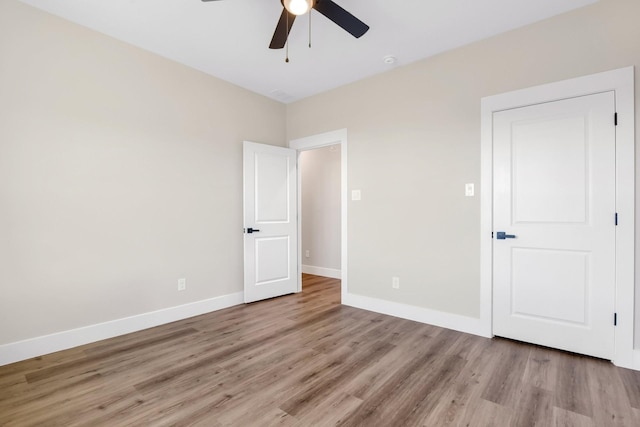 unfurnished bedroom featuring ceiling fan and light hardwood / wood-style flooring