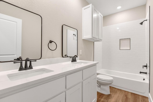 full bathroom with wood-type flooring, toilet, vanity, and shower / bathing tub combination