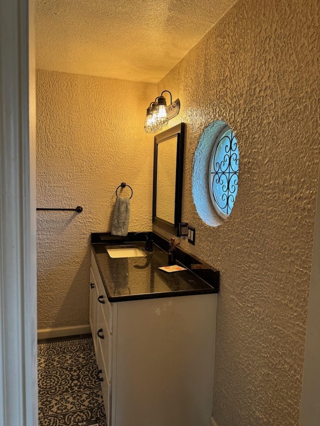 bathroom featuring a textured ceiling and vanity