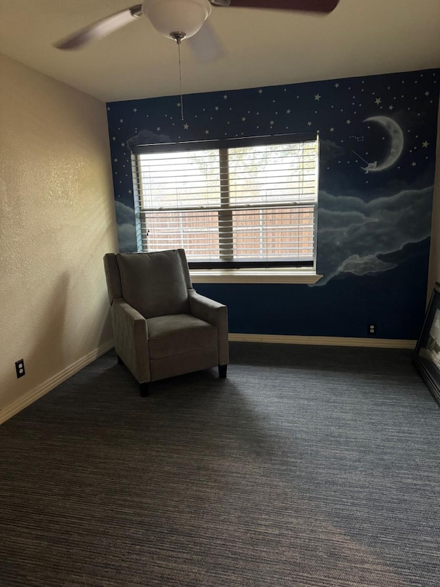 living area featuring ceiling fan and dark carpet