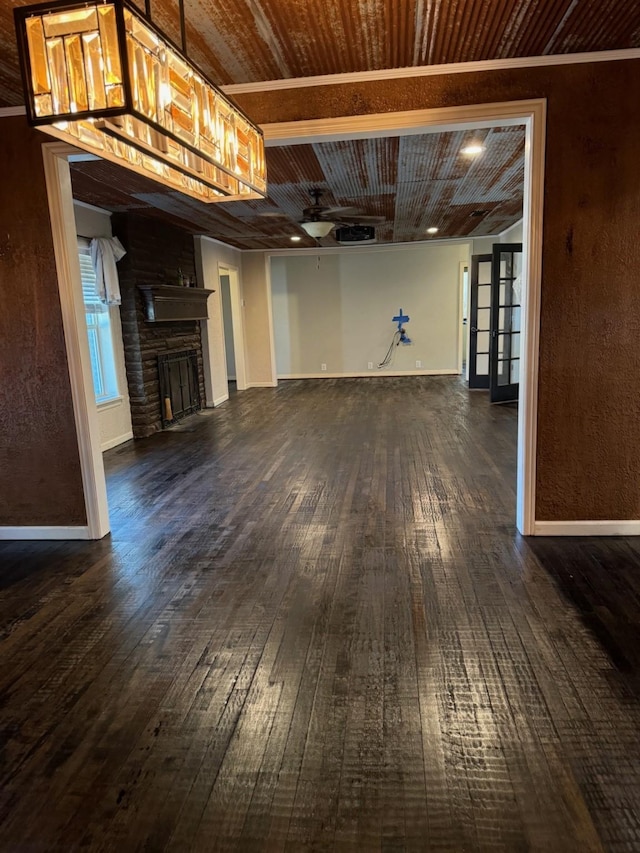 basement featuring a fireplace, dark hardwood / wood-style floors, and wooden ceiling