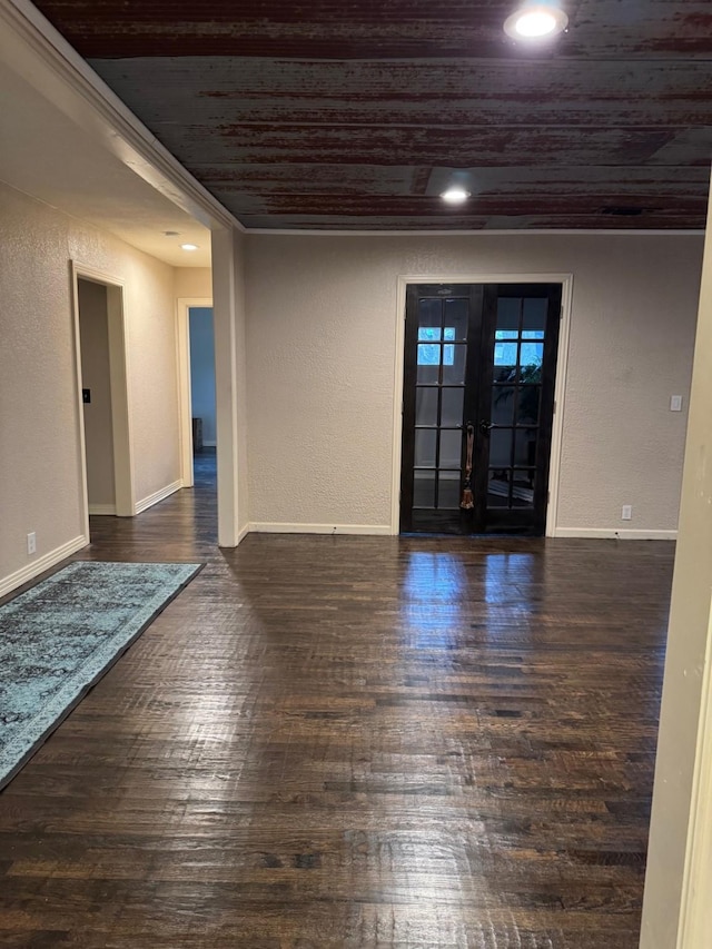 spare room with wooden ceiling, french doors, dark hardwood / wood-style floors, and ornamental molding