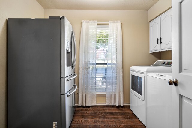 laundry area with a textured ceiling, washing machine and dryer, and dark wood-type flooring