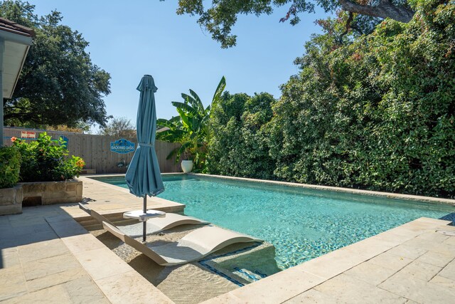 view of swimming pool featuring a patio