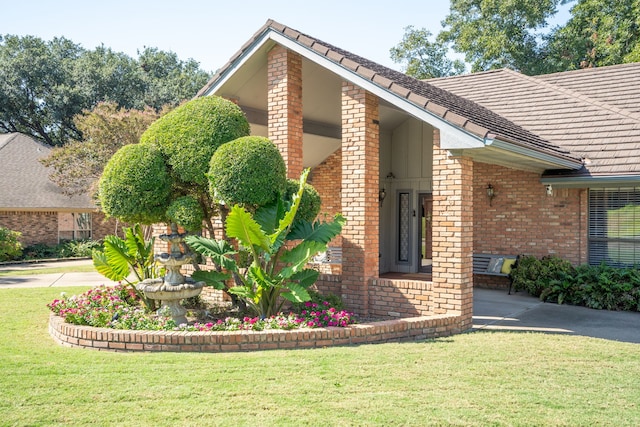 view of side of property with a lawn