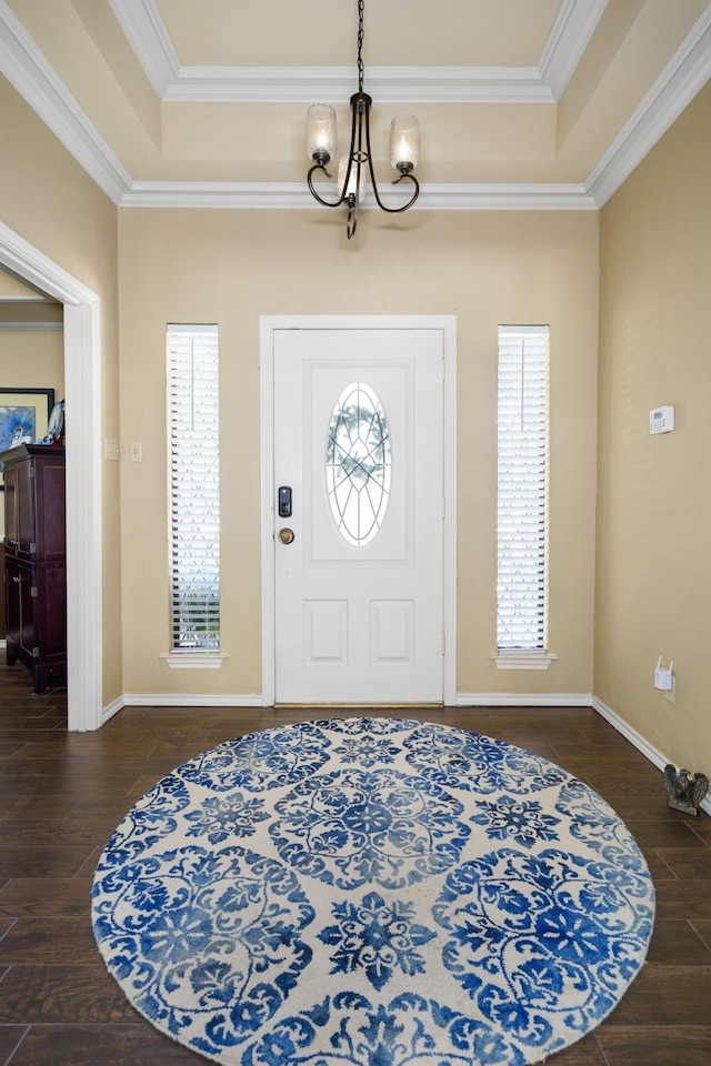 entryway featuring a wealth of natural light, crown molding, and dark hardwood / wood-style floors