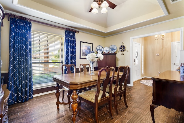 dining space featuring a tray ceiling, ceiling fan, dark hardwood / wood-style flooring, and vaulted ceiling