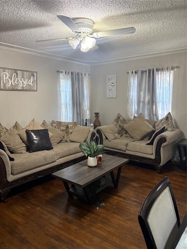 living room with crown molding, ceiling fan, and dark hardwood / wood-style floors