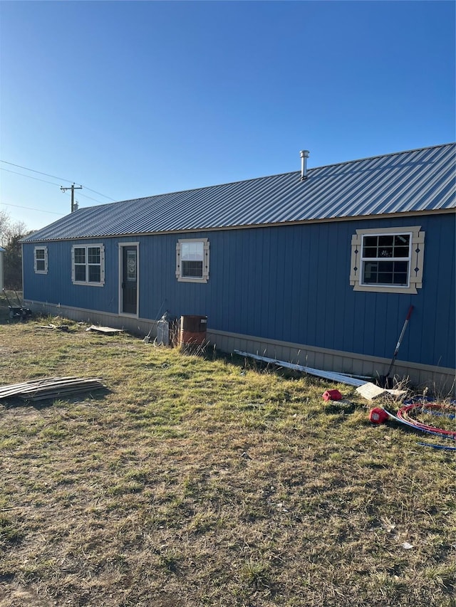 rear view of house with a yard