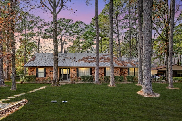 ranch-style house with a lawn