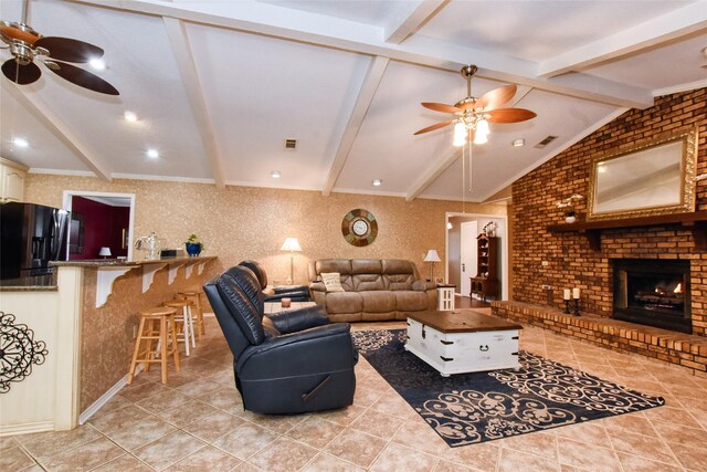 tiled living room with ceiling fan, a fireplace, and lofted ceiling with beams