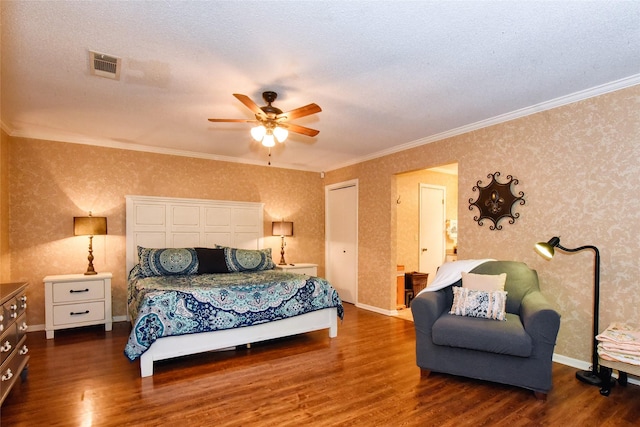 bedroom featuring a textured ceiling, ceiling fan, crown molding, and dark wood-type flooring