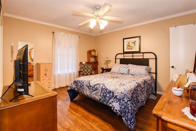 bedroom featuring hardwood / wood-style flooring, ceiling fan, and crown molding