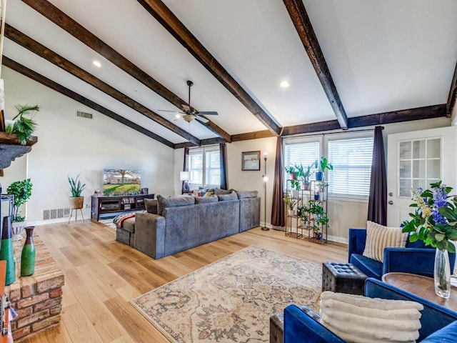 living room with hardwood / wood-style flooring, lofted ceiling with beams, and ceiling fan