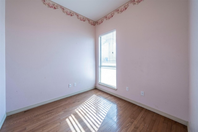 unfurnished room with light hardwood / wood-style flooring