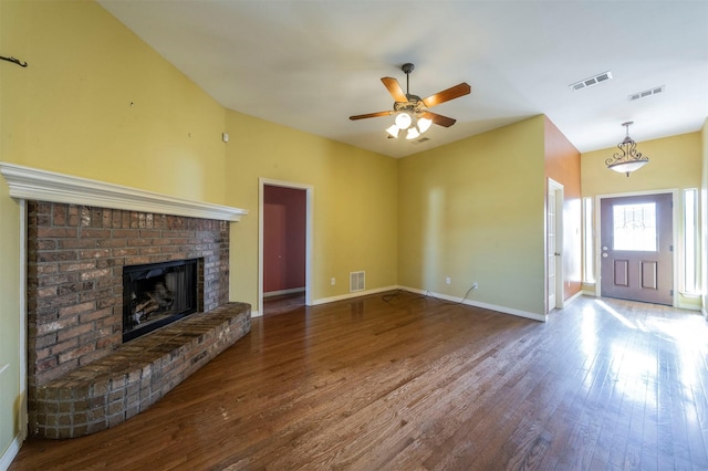 unfurnished living room featuring ceiling fan, hardwood / wood-style floors, and a brick fireplace