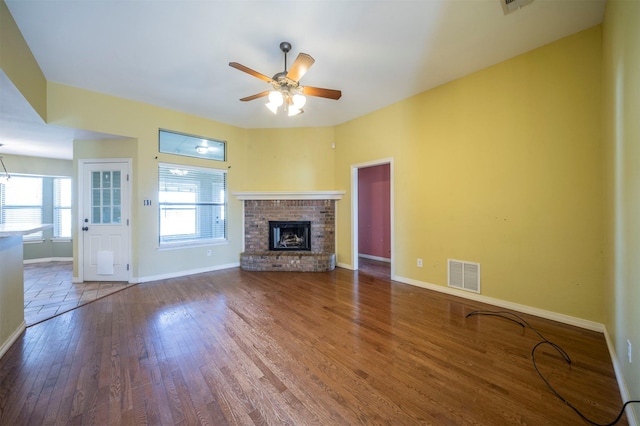 unfurnished living room with a fireplace, hardwood / wood-style flooring, and ceiling fan