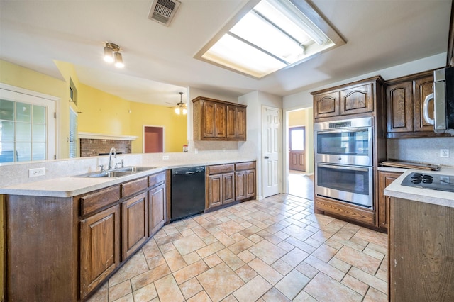 kitchen with ceiling fan, dishwasher, sink, white gas stovetop, and double oven