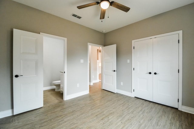 unfurnished bedroom with connected bathroom, a closet, ceiling fan, and light wood-type flooring