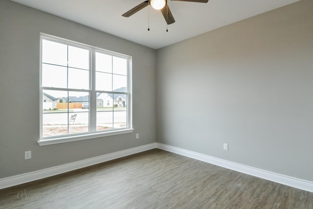 spare room with hardwood / wood-style flooring and ceiling fan