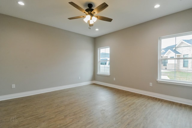 spare room featuring wood-type flooring and ceiling fan