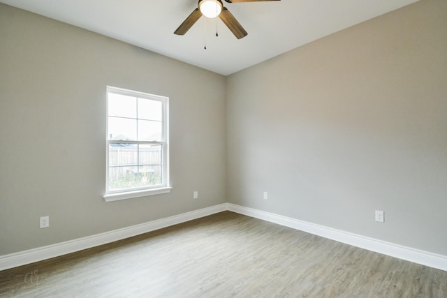 spare room featuring wood-type flooring and ceiling fan