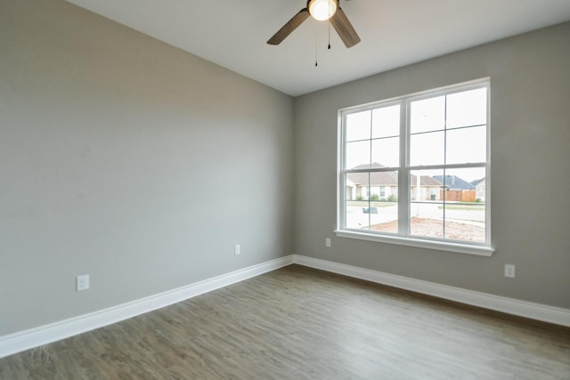 empty room featuring ceiling fan and hardwood / wood-style floors