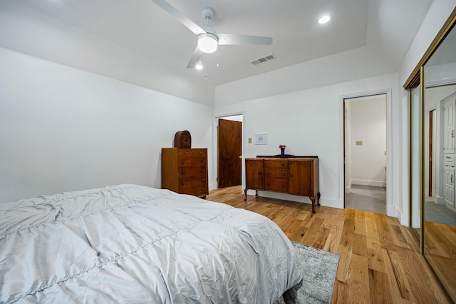 bedroom featuring ceiling fan, light wood-type flooring, and a closet