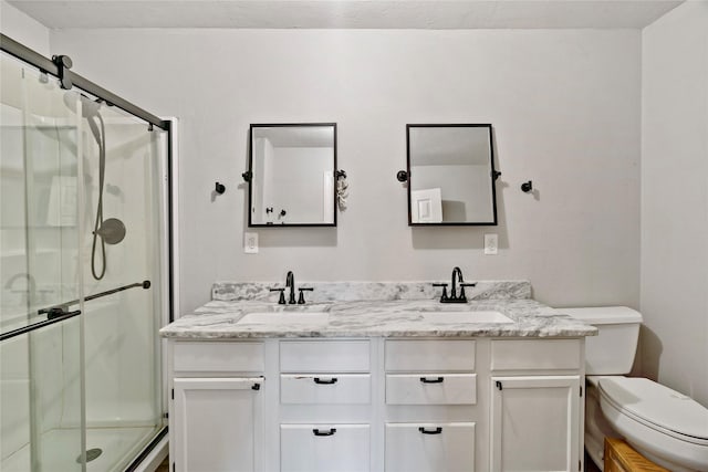 bathroom with vanity, toilet, and an enclosed shower