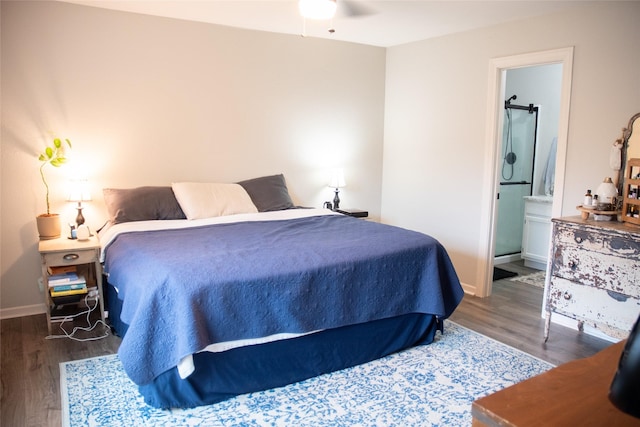 bedroom featuring ensuite bathroom, dark hardwood / wood-style floors, and ceiling fan