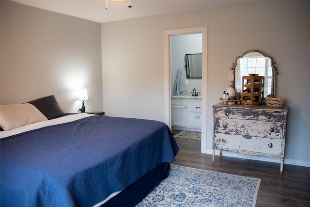 bedroom featuring dark hardwood / wood-style flooring and connected bathroom