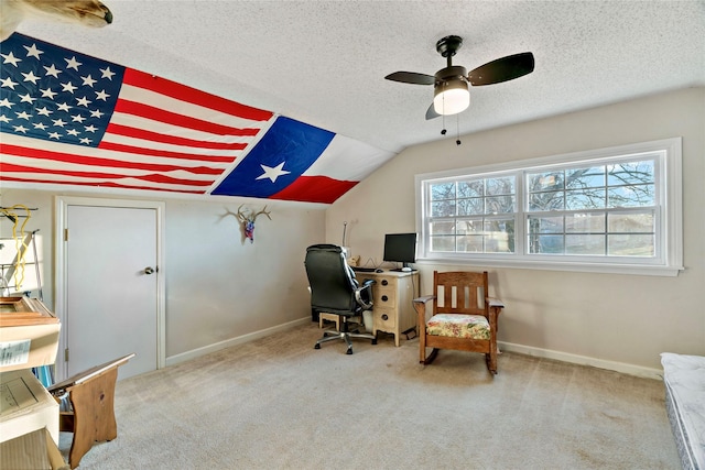 carpeted home office featuring ceiling fan, lofted ceiling, and a textured ceiling