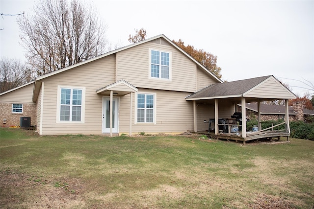 view of front of property featuring a front lawn and central AC unit